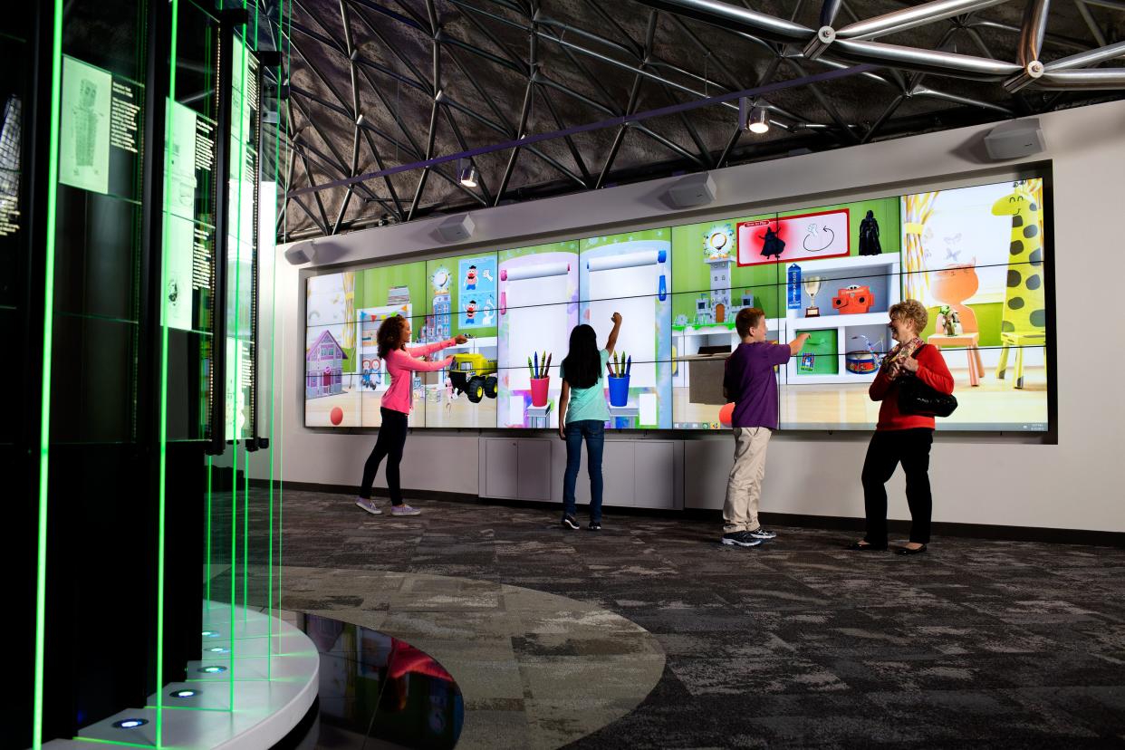 A 24-foot-long virtual playroom screen allows visitors to use Kinect motion control to play with classic toys and Crayon easels in the National Toy Hall of Fame at The Strong Museum in Rochester, New York.