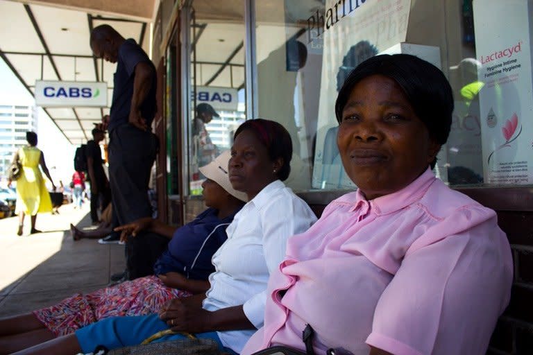 Siphiwe Esiphakathi sits with other women in a queue outside a bank in Bulawayo, Zimbabwe, hoping to get access to their cash. For many women, waiting for hours to get money in the midst of the country's cash shortage means skipping doctors' appointments or essential treatments. (Photo: Tendai Marima)