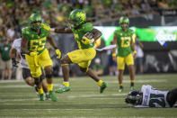 Oregon running back Noah Whittington (6) gets past Hawaii defensive back Justin Sinclair (21) during the second half of an NCAA college football game Saturday, Sept. 16, 2023, in Eugene, Ore. (AP Photo/Andy Nelson)