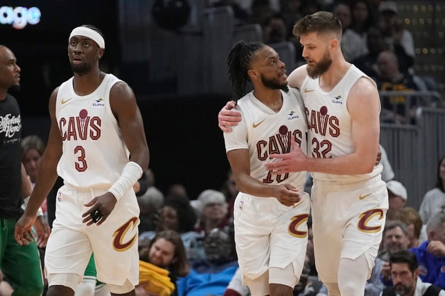 Cleveland Cavaliers’ Caris LeVert (3), Darius Garland, center, and <a class="link " href="https://sports.yahoo.com/nba/players/6256/" data-i13n="sec:content-canvas;subsec:anchor_text;elm:context_link" data-ylk="slk:Dean Wade;sec:content-canvas;subsec:anchor_text;elm:context_link;itc:0">Dean Wade</a> (32) walk off the court during a timeout in the first half of Game 3 of the team’s NBA basketball second-round playoff series against the Boston Celtics, Saturday, May 11, 2024, in Cleveland. (AP Photo/Sue Ogrocki)