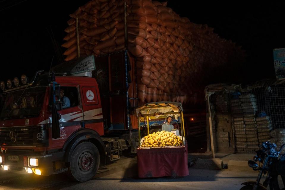 A man waits for clients while selling mangoes from his street stall in the late afternoon in Kandahar City, Afghanistan, on June 12.<span class="copyright">Rodrigo Abd—AP</span>