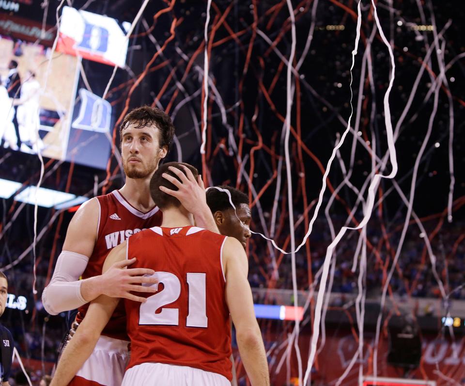 Wisconsin Badgers forward Frank Kaminsky hugs teammate Wisconsin Badgers guard Josh Gasser after a 68-63 loss to Duke during the  NCAA Men's Basketball Championship game at  Lucas Oil Stadium in Indianapolis, Indiana, Monday, April 6, 2015.