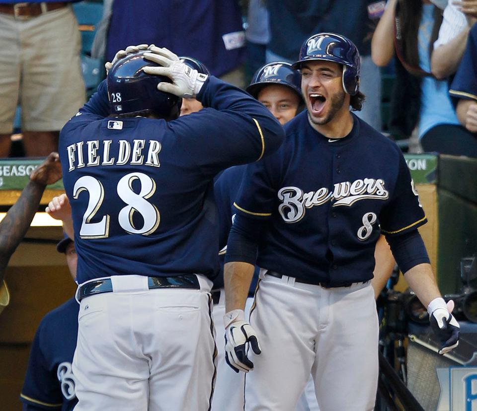 Ryan Braun congratulates Prince Fielder after Fielder's two-run homer in the fifth inning Oct. 9, 2011, gives the Brewers a 6-5 lead over the St. Louis Cardinals. The homer was part of a six-run outburst to take control of Game 1 of the NLCS.