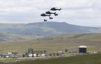 South African army helicopters fly over the grave of late President Nelson Mandela at the graveyard within the Mandela family's property in the village of Qunu December 15, 2013. REUTERS/Kai Pfaffenbach (SOUTH AFRICA)