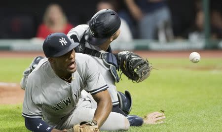 Jul 14, 2018; Cleveland, OH, USA; New York Yankees third baseman Miguel Andujar (41) and catcher Austin Romine (28) attempt to field a pop up hit by Cleveland Indians right fielder Brandon Guyer during the ninth inning at Progressive Field. Mandatory Credit: Ken Blaze-USA TODAY Sports