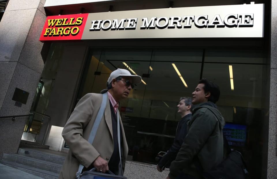 Pedestrians walk by a Wells Fargo home mortgage office on October 11, 2013 in San Francisco, California. (Photo by Justin Sullivan/Getty Images)