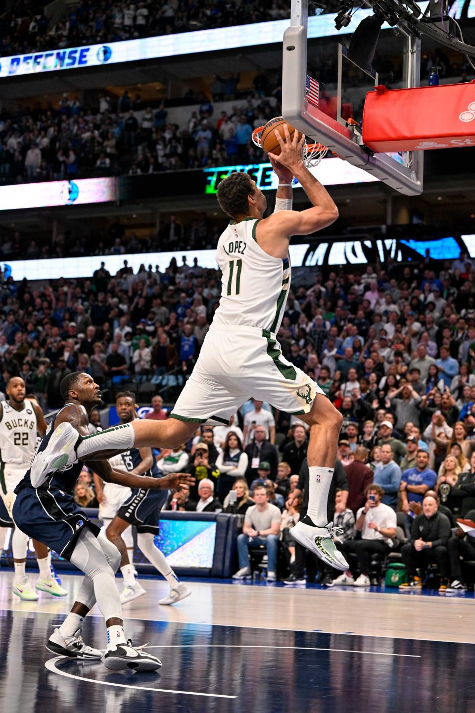 Bucks center Brook Lopez goes up for the winning basket with 7.1 seconds left in the game against the Mavericks on Friday night.