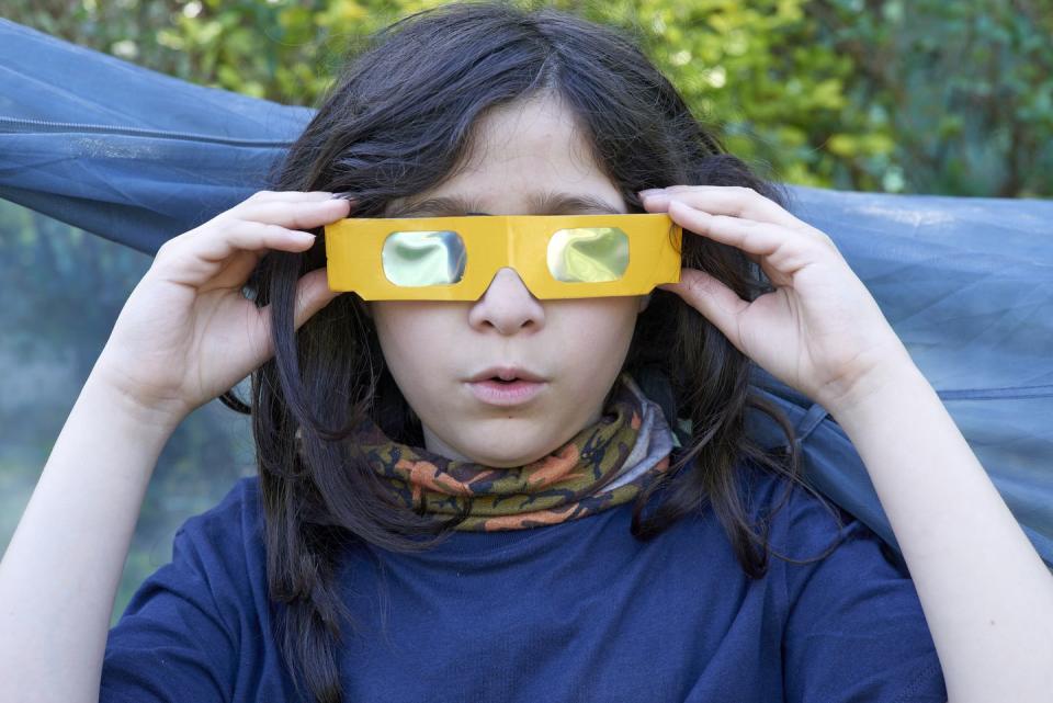 teenage boy with eclipse glasses