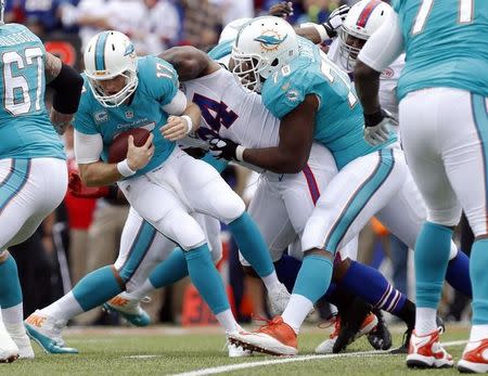 Miami Dolphins quarterback Ryan Tannehill (17) is sacked by Buffalo Bills defensive end Mario Williams (94) during the first quarter at Ralph Wilson Stadium. Mandatory Credit: Kevin Hoffman-USA TODAY