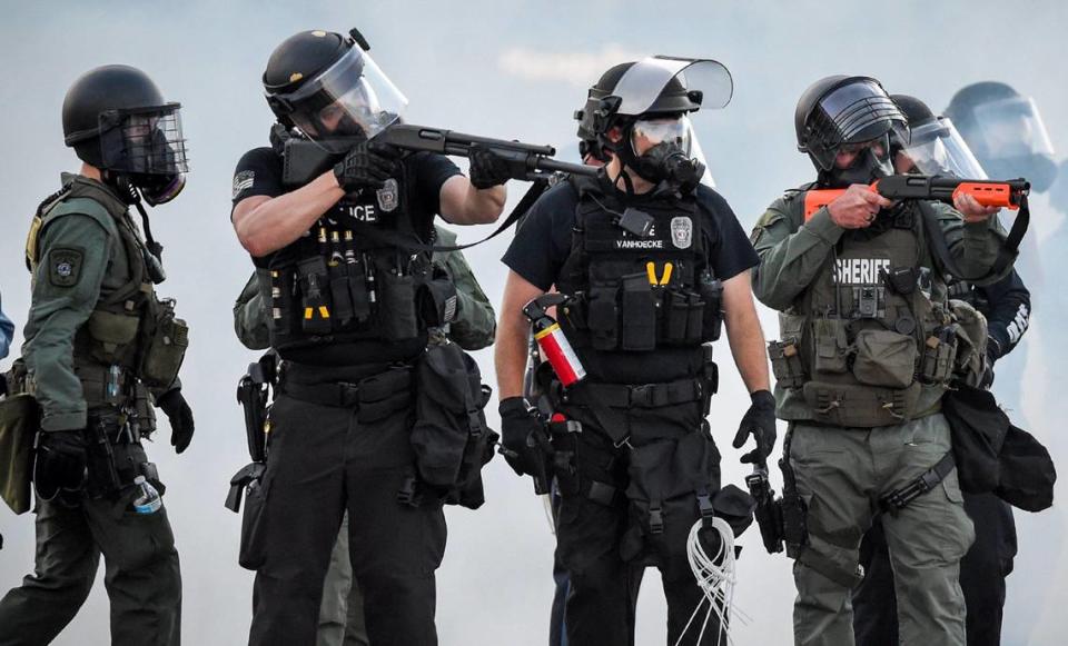 During a third night of protests, members of the Kansas City police and Jackson County Sheriff launched tear gas and drew weapons after bottles and other objects were thrown at officers Sunday night, May 31, 2020, near the Country Club Plaza in Kansas City. Violent protests have been erupting all over the country after George Floyd, an African American, died in police custody on Memorial Day in Minneapolis.