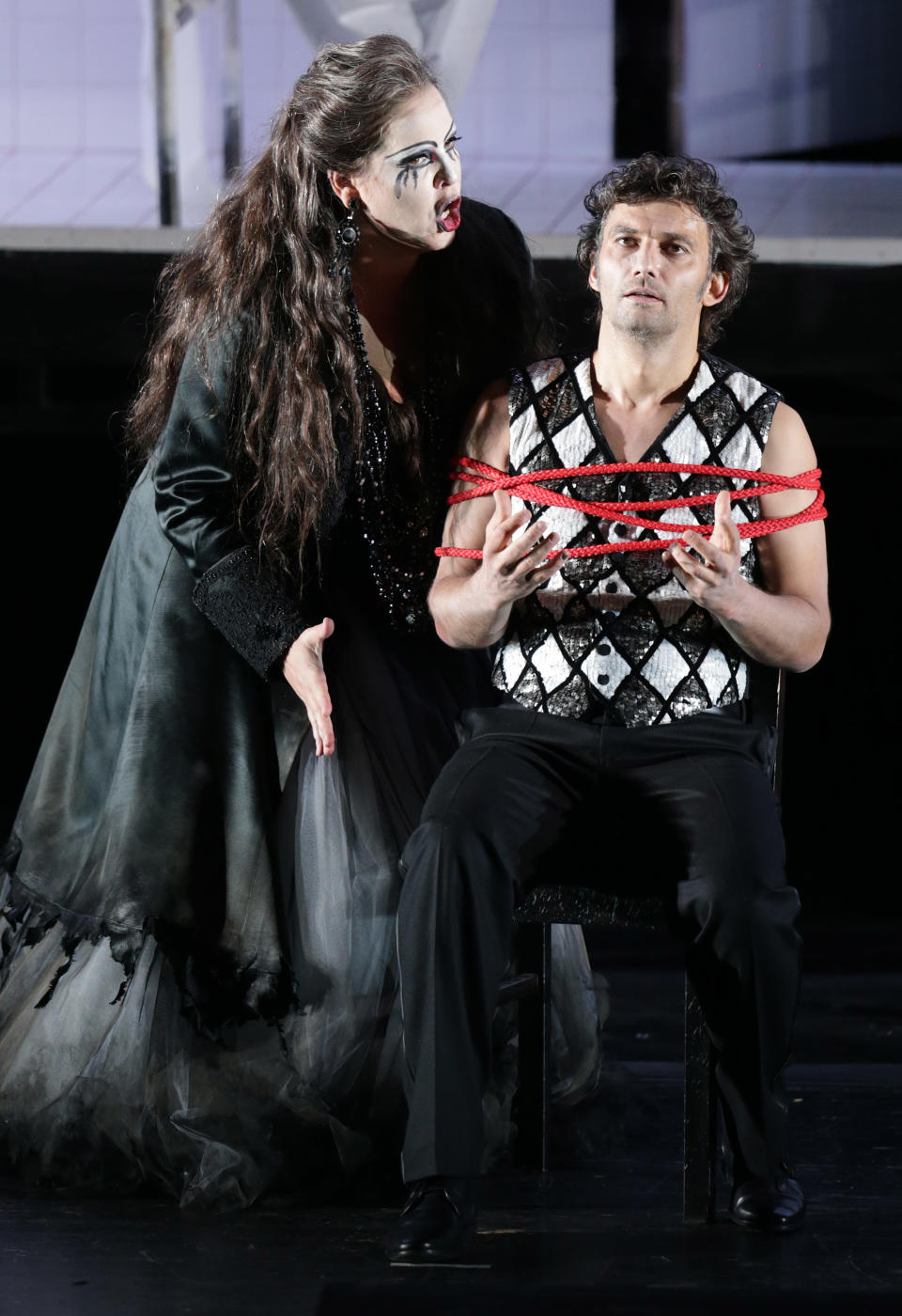 In this picture taken Friday, June 21, 2013, Jonas Kaufmann, right, in the role of Manrico and Elena Manistina as Azucena sing during a dress rehearsal for the opera "Il Trovatore" by Giuseppe Verdi in the Bavarian State Opera House in Munich, southern Germany. This wild new production by Olivier Py opened the company's annual Munich Opera Festival. It's a non-stop barrage of nightmarish images mixing styles and periods that assault the audience at lightning speed on a multi-tiered revolving set. (AP Photo/Matthias Schrader)