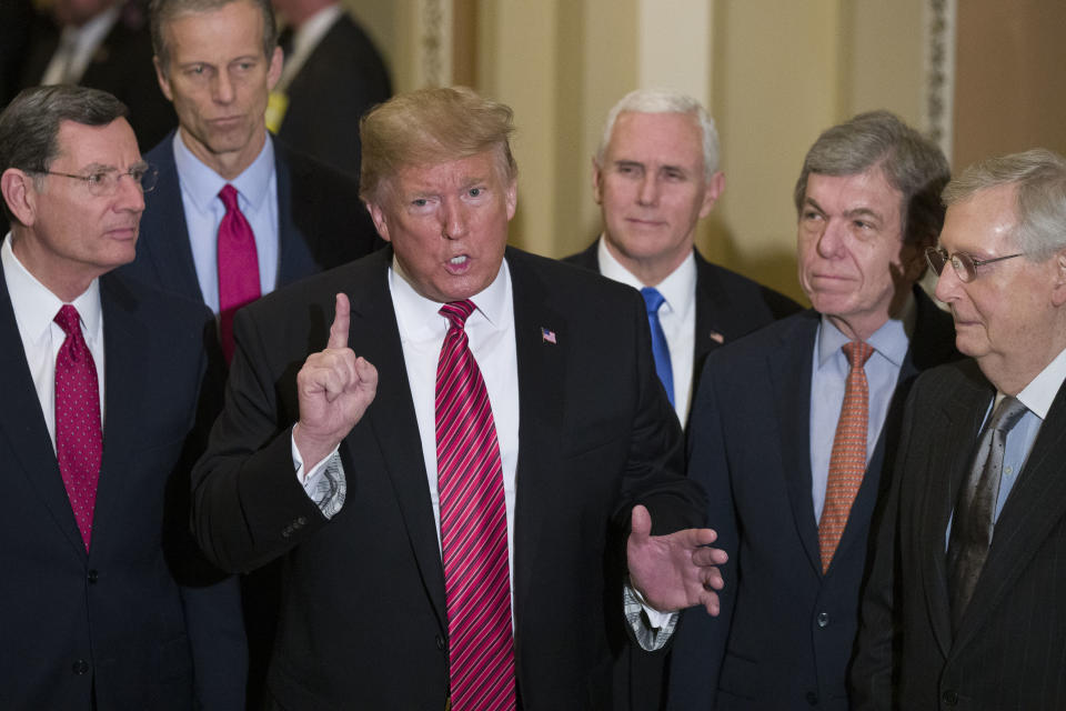 Sen. John Barrasso, R-Wyo., left, and Sen. John Thune, R-S.D., stand with President Donald Trump, Vice President Mike Pence, Sen. Roy Blunt, R-Mo., and Senate Majority Leader Mitch McConnell of Ky., as Trump speaks while departing after a Senate Republican Policy luncheon, on Capitol Hill in Washington, Wednesday, Jan. 9, 2019. (AP Photo/Alex Brandon)