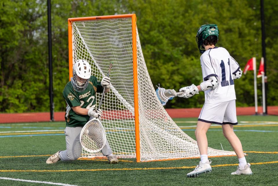 St. Mary Catholic Central goalie Jason Hawkins makes a save against Ann Arbor Greenhills during a 10-6 SMCC win on Monday, May 13, 2024.