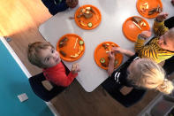 Preschool children eat lunch at a day care facility, Monday, Oct. 25, 2021, in Mountlake Terrace, Wash. Child care centers once operated under the promise that it would always be there when parents have to work. Now, each teacher resignation, coronavirus exposure, and day care center closure reveals an industry on the brink, with wide-reaching implications for an entire economy's workforce. (AP Photo/Elaine Thompson)