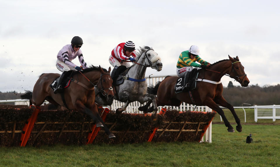 Eventual winner Champ ridden by Barry Geraghty (right) jumps the last with Kateson and Getaway Trump