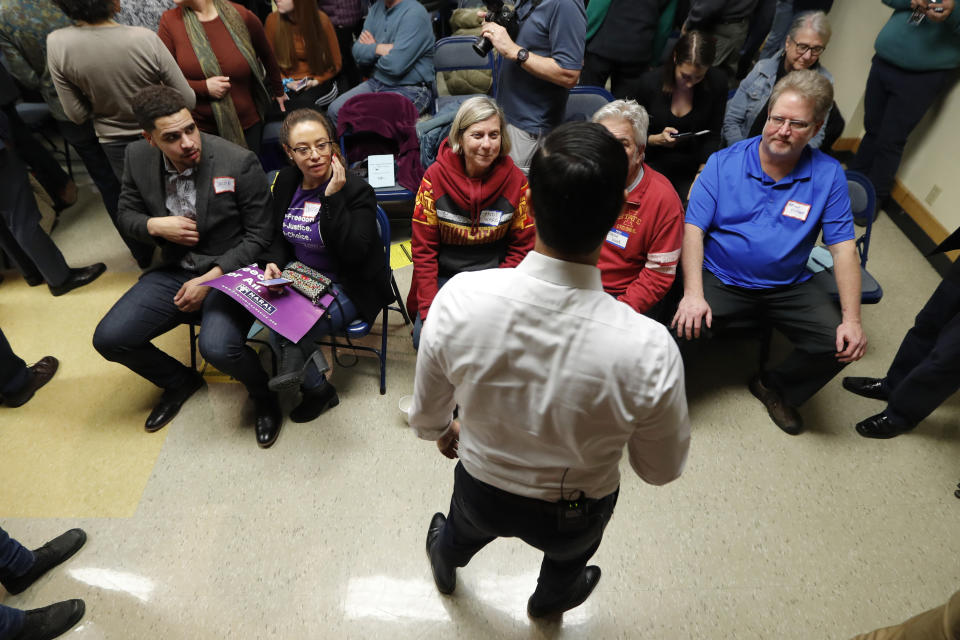 Former Housing and Urban Development Secretary and 2020 Democratic presidential hopeful Julian Castro, center, speaks to local residents at the Story County Democrats' annual soup supper fundraiser, Saturday, Feb. 23, 2019, in Ames, Iowa. (AP Photo/Charlie Neibergall)