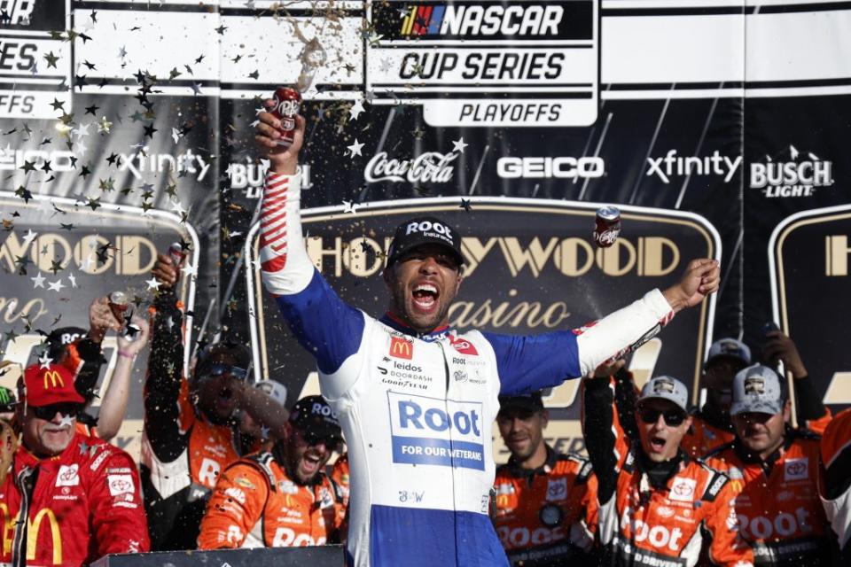 KANSAS CITY, KANSAS - SEPTEMBER 11: Bubba Wallace, driver of the #45 ROOT Insurance Toyota, celebrates in victory lane after winning the NASCAR Cup Series Hollywood Casino 400 at Kansas Speedway on September 11, 2022 in Kansas City, Kansas. (Photo by Chris Graythen/Getty Images)