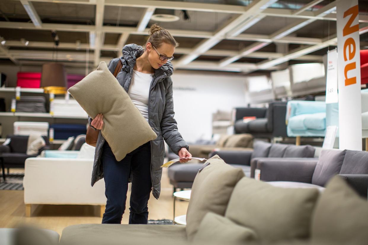 woman choosing new furniture in a modern home furnishings store