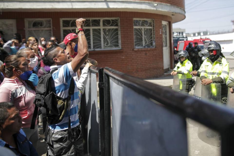 <div class="inline-image__caption"><p>Relatives of inmates gathered outside La Modelo jail in Bogota, Colombia, Sunday, March 22, 2020. Violence broke out in the prison out of inmates' fears that prison guards were not doing enough to prevent coronavirus inside overcrowded prisons.</p></div> <div class="inline-image__credit">Ivan Valencia/AP</div>