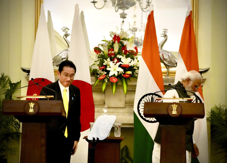 Indian Prime Minister Narendra Modi and his Japanese counterpart Fumio Kishida walk during a signing of agreements and joint press conference in New Delhi, Saturday, March 19, 2022. Kishida Saturday said his country will invest $42 billion in India over the next five years in a deal that is expected to boost bilateral trade between New Delhi and Tokyo. (AP Photo/Manish Swarup)