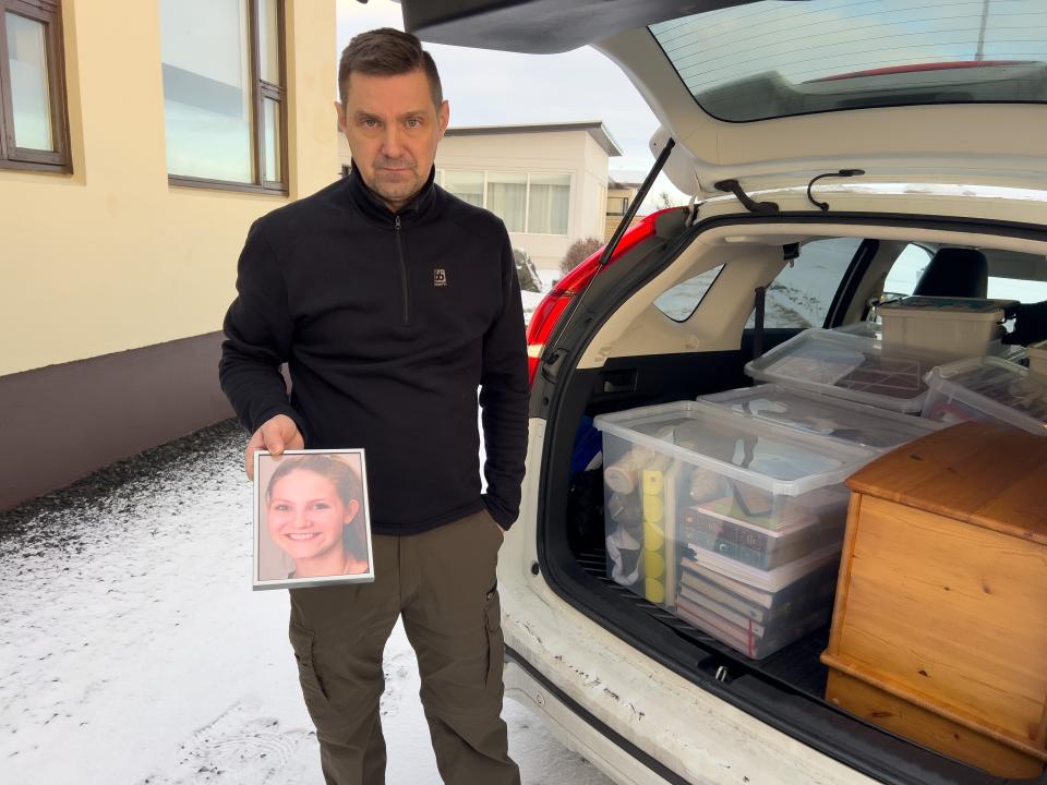 A Grindavik resident packs up his belongings including a picture of his daughter Alma, who was killed in a car accident several years ago (Getty Images)