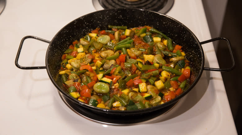 vegetables cooking in paella pan 