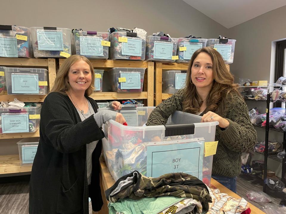 Tess Frear, right, executive director of Helping Mamas Knoxville, and caseworker Courtnie Mizer with Destiny Adoption Services look for warm winter clothes for a client Dec. 27, 2022.