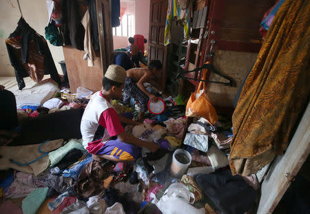 Residents who stayed at evacuation centers, due to the assault of government troops against pro-Islamic State militant groups, start cleaning their house after they were allowed to return to Basak, Malutlut district in Marawi city, Philippines October 29, 2017. REUTERS/Romeo Ranoco