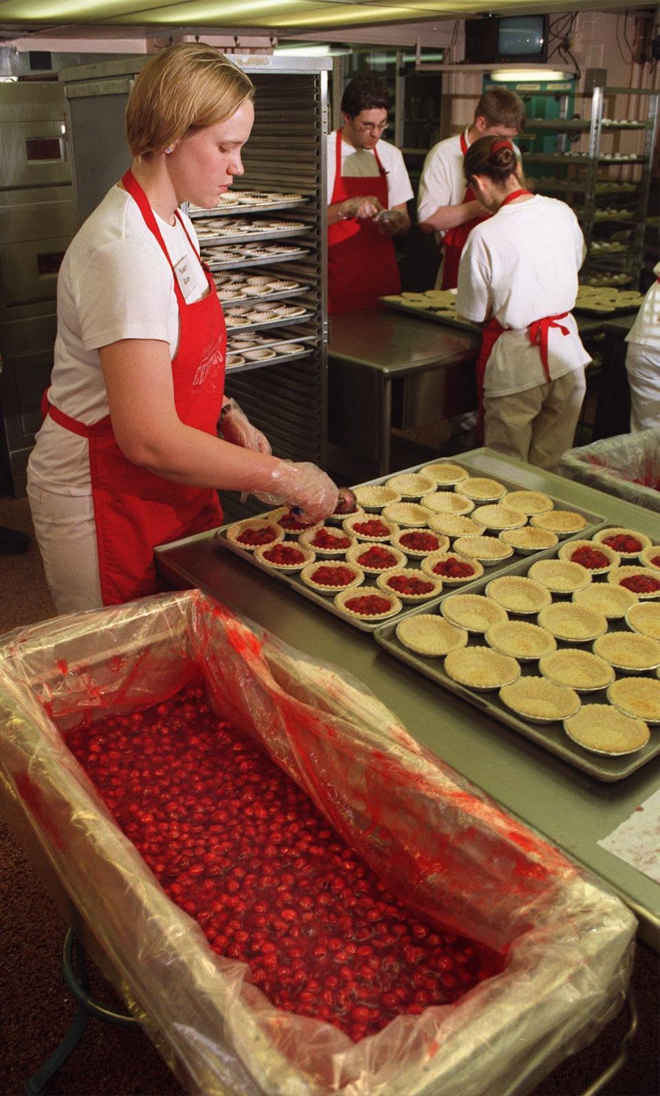 From April 1999: Nancy Rens, an Iowa State University student in hotel, restaurant and institution management, fills dozens of pie crusts with cherry filling. The pies are an annual Veishea event. Rens is a sophomore from Larchwood. The pies were being prepared at MacKay Hall on the Iowa State campus.