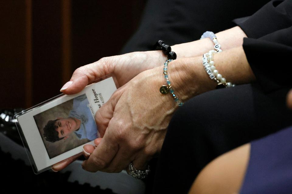 Gena Hoyer holds a photograph of her son, Luke, who was killed in the 2018 shootings, as she awaits the verdict in the trial of Marjory Stoneman Douglas High School shooter Nikolas Cruz at the Broward County Courthouse in Fort Lauderdale on Thursday, Oct. 13, 2022. Cruz, who plead guilty to 17 counts of premeditated murder in the 2018 shootings, is the most lethal mass shooter to stand trial in the U.S. He was previously sentenced to 17 consecutive life sentences without the possibility of parole for 17 additional counts of attempted murder for the students he injured that day. 