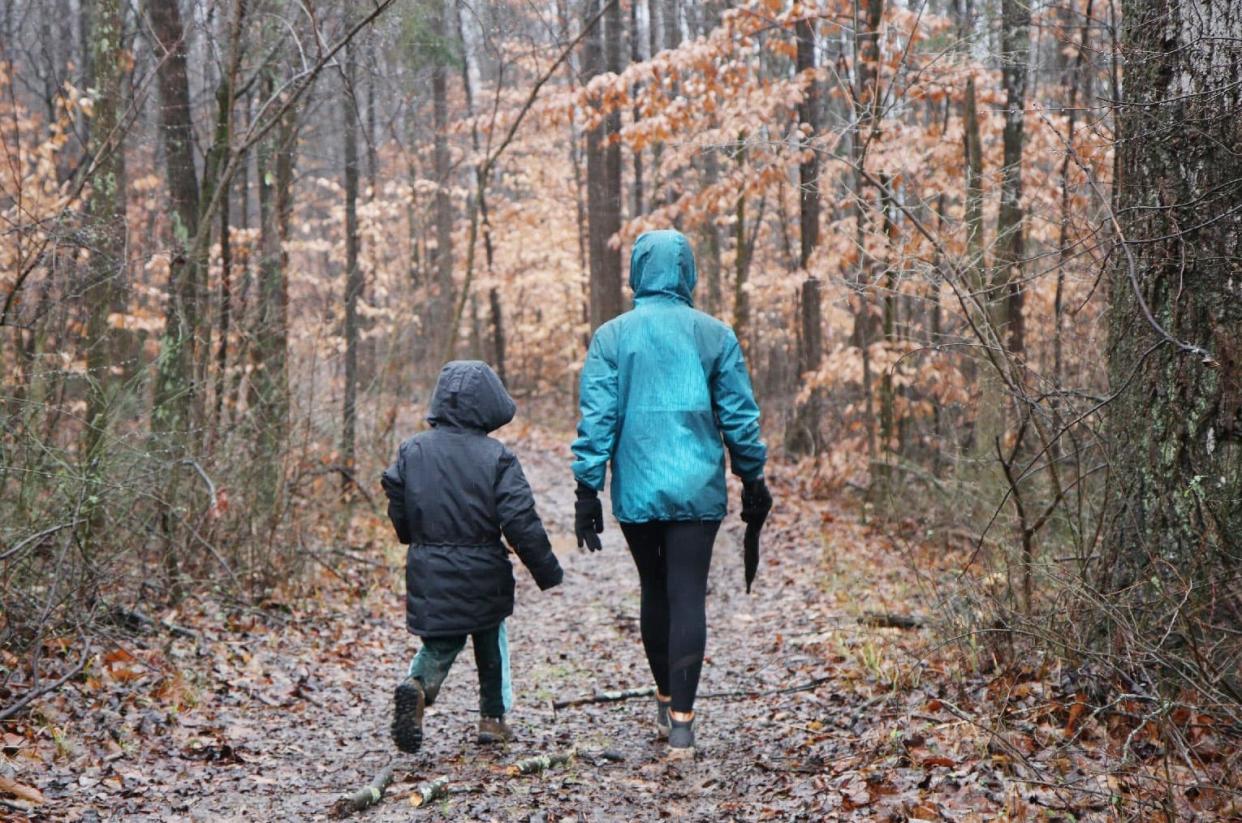 Walking through the woods on a rainy day are two participants in the 2022 First Day Trail Run at Fairfax State Recreation Area. Some of the trails used during the trail run in past years are now part of three new trails in the state rec area at Lake Monroe.