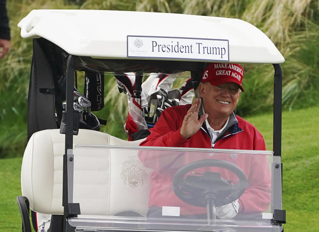 Former US president Donald Trump smiles as he drives in a buggy during a round of golf at Trump International Golf Links & Hotel in Doonbeg, Ireland, Thursday, May 4, 2023, during his visit to Ireland. (Brian Lawless/PA via AP)