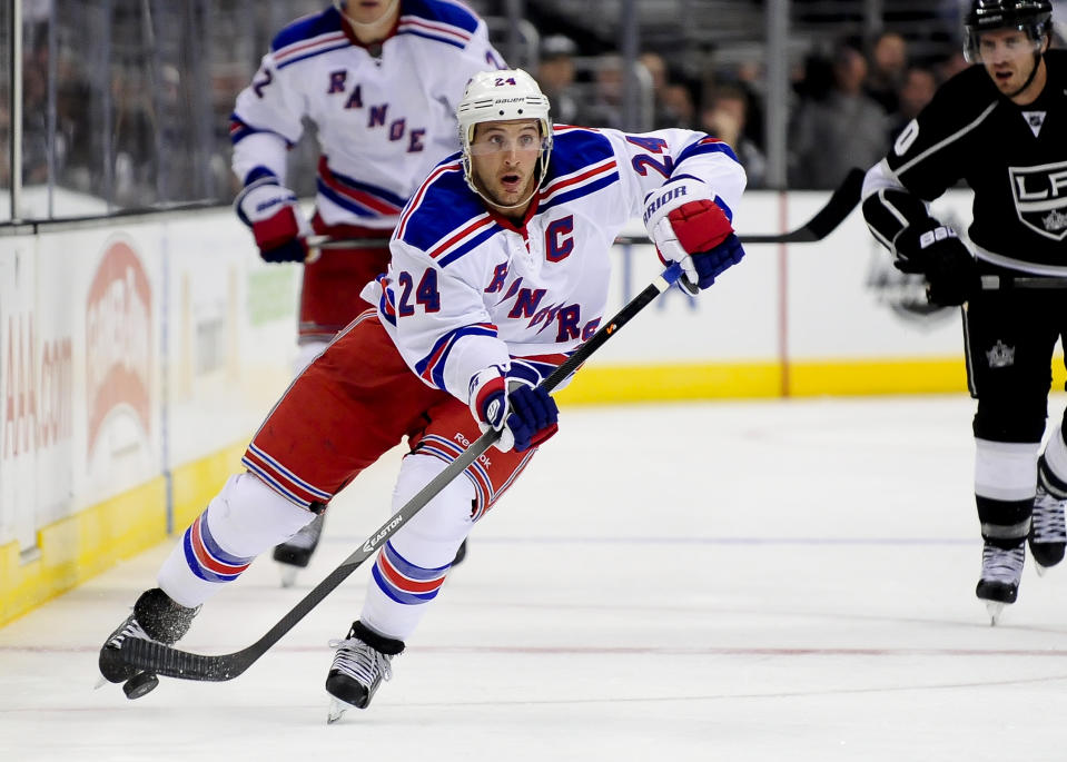 FILE - In this Oct. 7, 2013 file photo, New York Rangers right wing Ryan Callahan moves the puck up the ice during the third period of their NHL hockey game against the Los Angeles Kings,in Los Angeles. The Rangers and Tampa Bay Lightning are pulling off the first major deal on NHL trade deadline day, Wednesday, March 5, 2014, swapping captains Ryan Callahan and Martin St. Louis. (AP Photo/Gus Ruelas, File)