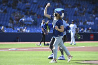 Canadian Olympian Penny Oleksiak throws out the ceremonial first pitch before the start of a baseball game between the Toronto Blue Jays and the Minnesota Twins in Toronto on Saturday, Sept. 18, 2021. (Jon Blacker/The Canadian Press via AP)