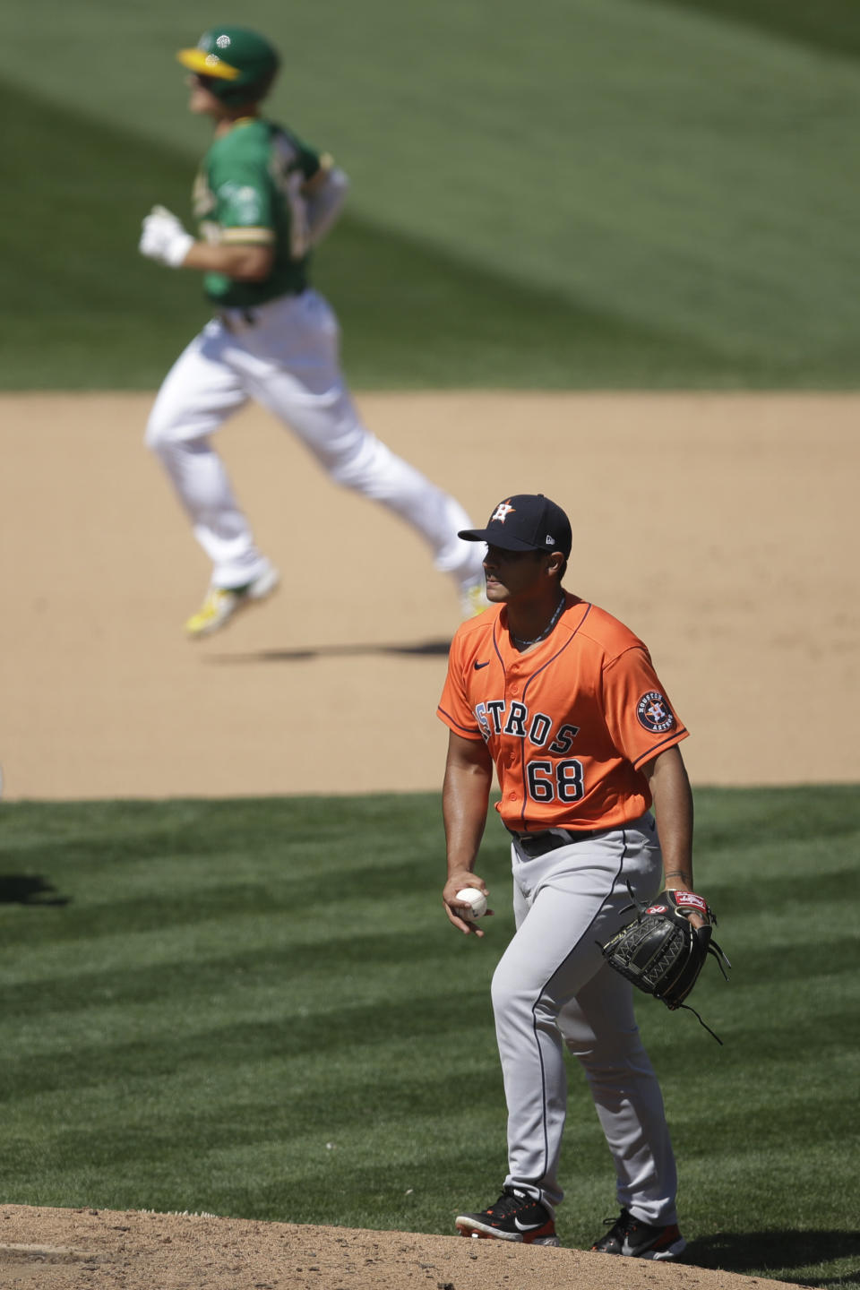 Houston Astros' Nivaldo Rodriguez (68) waits for Oakland Athletics' Matt Chapman to run the bases after hitting a home run in the eighth inning of a baseball game Saturday, Aug. 8, 2020, in Oakland, Calif. (AP Photo/Ben Margot)