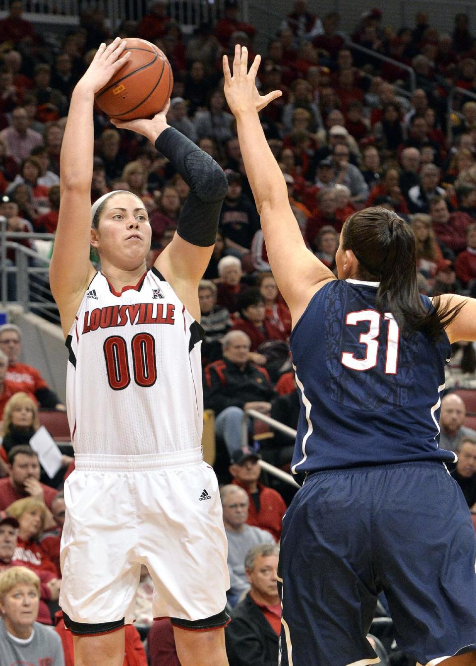 Louisville's Sara Hammond, left, puts up a shot over the defense of Connecticut's Stefanie Dolson during the first half of an NCAA college basketball game, Monday, March 3, 2014, in Louisville, Ky. (AP Photo/Timothy D. Easley)