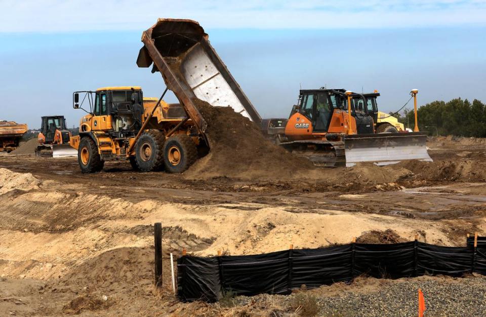 Heavy equipment redistributes dirt on the site of the new LivAway Suites 126-unit extended stay hotel project north of Columbia Center mall.