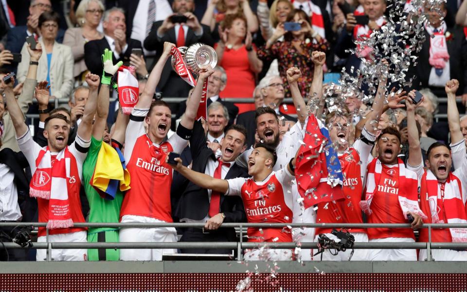 Arsenal lift the trophy after beating Chelsea 2-1 in the 136th FA Cup final - AP
