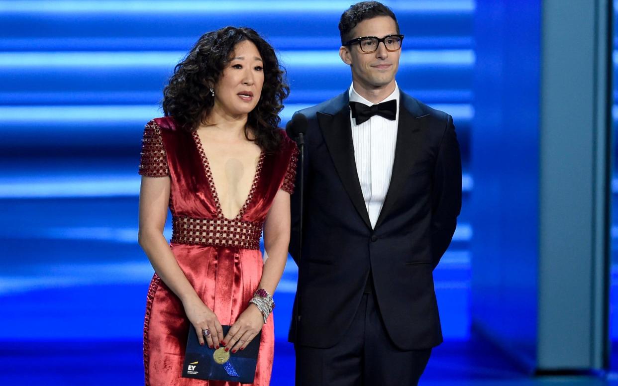 Sandra Oh and Andy Samberg presented an award at the Emmys, in September 2018. They will host the Golden Globes on Sunday night - Invision