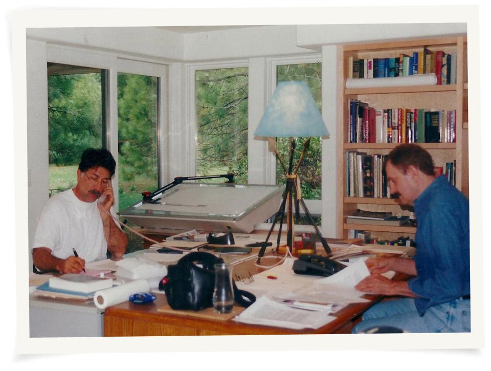 Frank and Alexander working in their office.