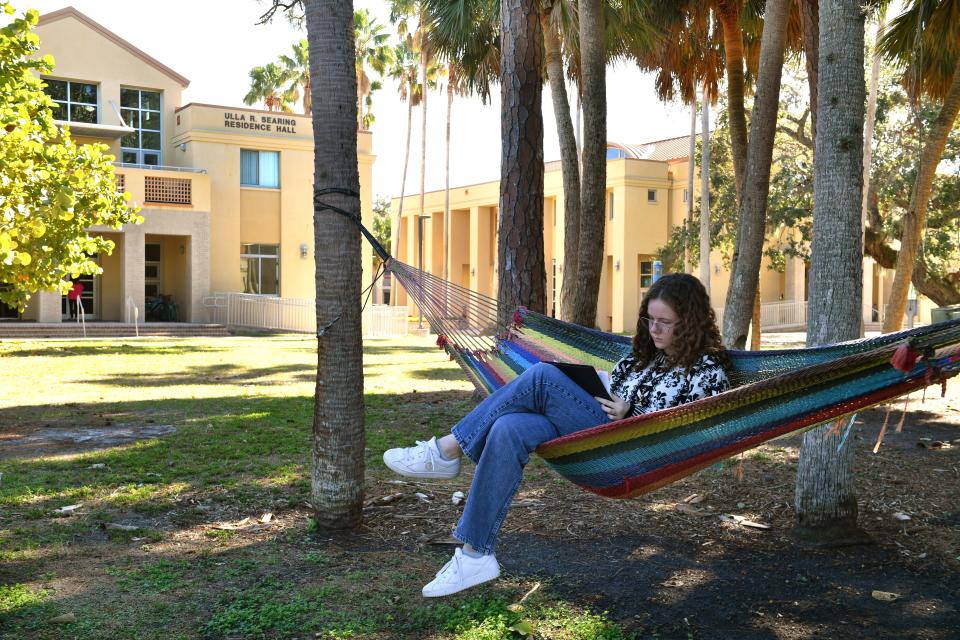 Margo Nielsen, 19, a first-year student studying biology and art, finds a shady spot to read on the New College of Florida campus in Sarasota earlier this month.