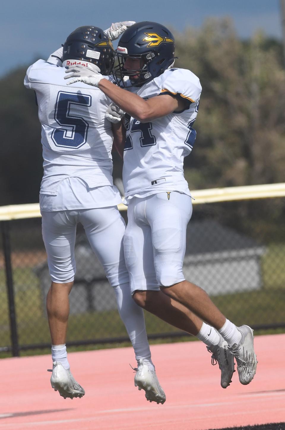 Victor's Adam Ruffalo and teammate Keith Kriegelstein celebrate Ruffalo's kickoff return for a touchdown in the first quarter against Churchville-Chili.