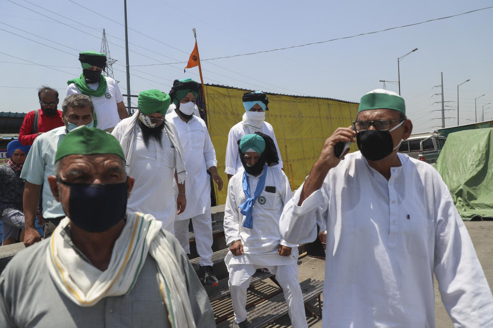 Farmers wear black bands across their faces as they gather for a protest in Ghazipur, outskirts of New Delhi, India, Wednesday, May 26, 2021.Farmers are marking 6 months of their agitation against the new agricultural laws they say will leave them poorer and at the mercy of big corporations. The government has billed the laws as necessary to modernize agriculture. Multiple rounds of talks between the government and farmers have failed to end the stalemate. (AP Photo/Amit Sharma)
