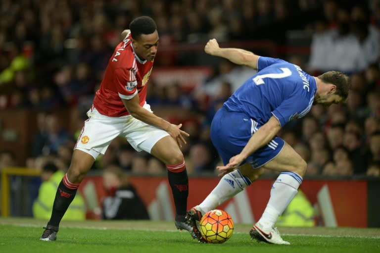 Manchester United's Anthony Martial (L) takes on Chelsea's Branislav Ivanovic during their English Premier League match, at Old Trafford in Manchester, on December 28, 2015