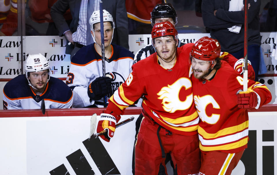 Edmonton Oilers players watch as Calgary Flames forward Matthew Tkachuk, left, celebrates his goal with defenseman Rasmus Andersson during the third period of Game 1 of an NHL hockey second-round playoff series Wednesday, May 18, 2022, in Calgary, Alberta. (Jeff McIntosh/The Canadian Press via AP)