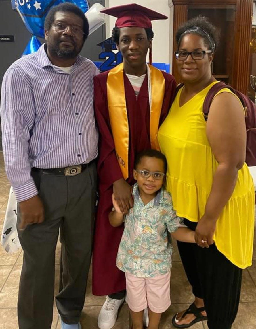 Devin Seymour is all smiles at his graduation celebration with his parents, Quazi Smith and Tamika Cobb and his nephew.