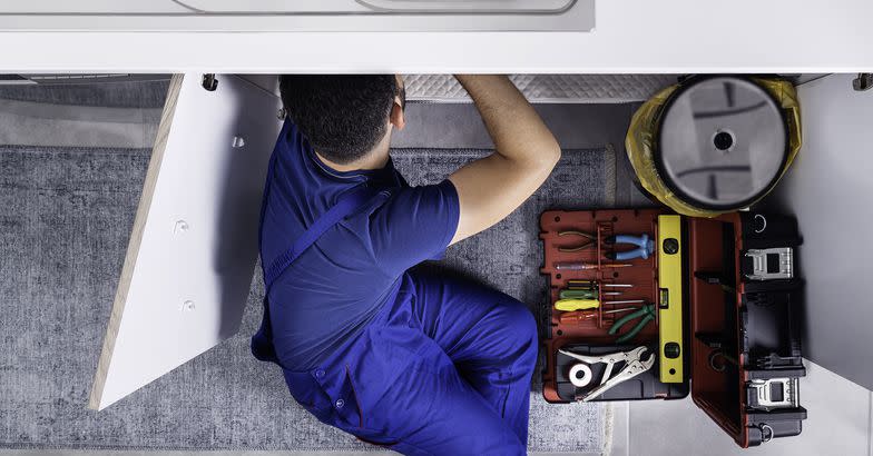 plumber working on sink