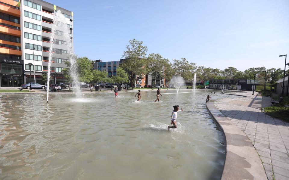 With temperatures reaching 90 degrees parents came down with their children and let them cool off at the fountain at Martin Luther King Jr. Memorial Park at Manhattan Square Park while they sat in the shade.