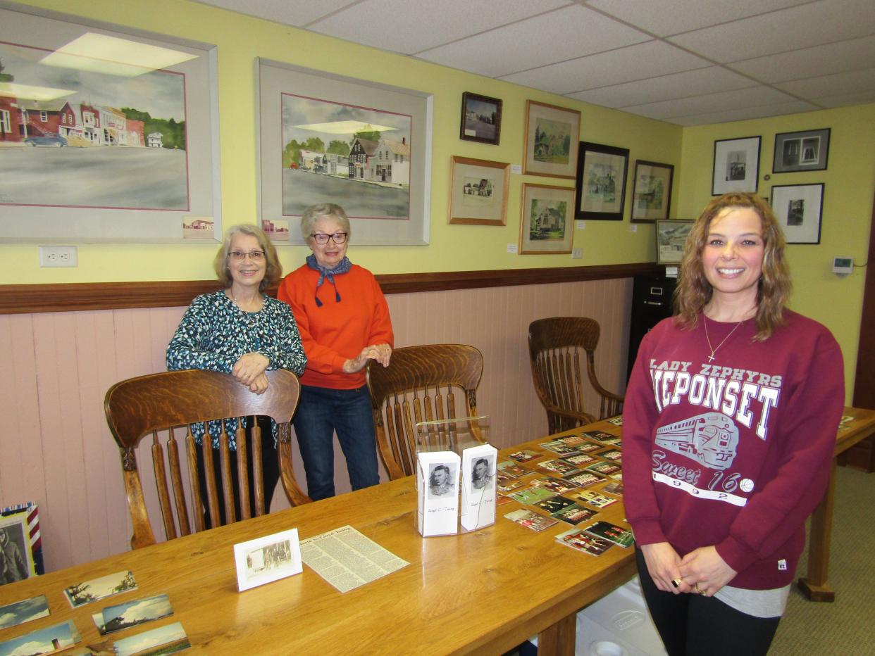 An exhibit of paintings of local scenes by Neponset native Lloyd Twing, many temporarily on loan by private individuals, is now on display at the Neponset Historical Museum, which recently received a $5,000 Illinois Humanities grant. In the photo are, from left, volunteers Julie Witte, Carolyn Miller and Jessica Seiden.