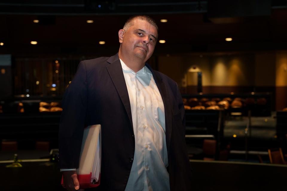 Claude Jackson Jr. holds the script to his play "Cashed Out" as he stands on a stage at Wild Horse Pass Casino for a portrait on Dec. 29, 2022, in Chandler. Jackson's play is set in Arizona, where he holds a career in public defense in the Gila River Indian Community Tribal government.